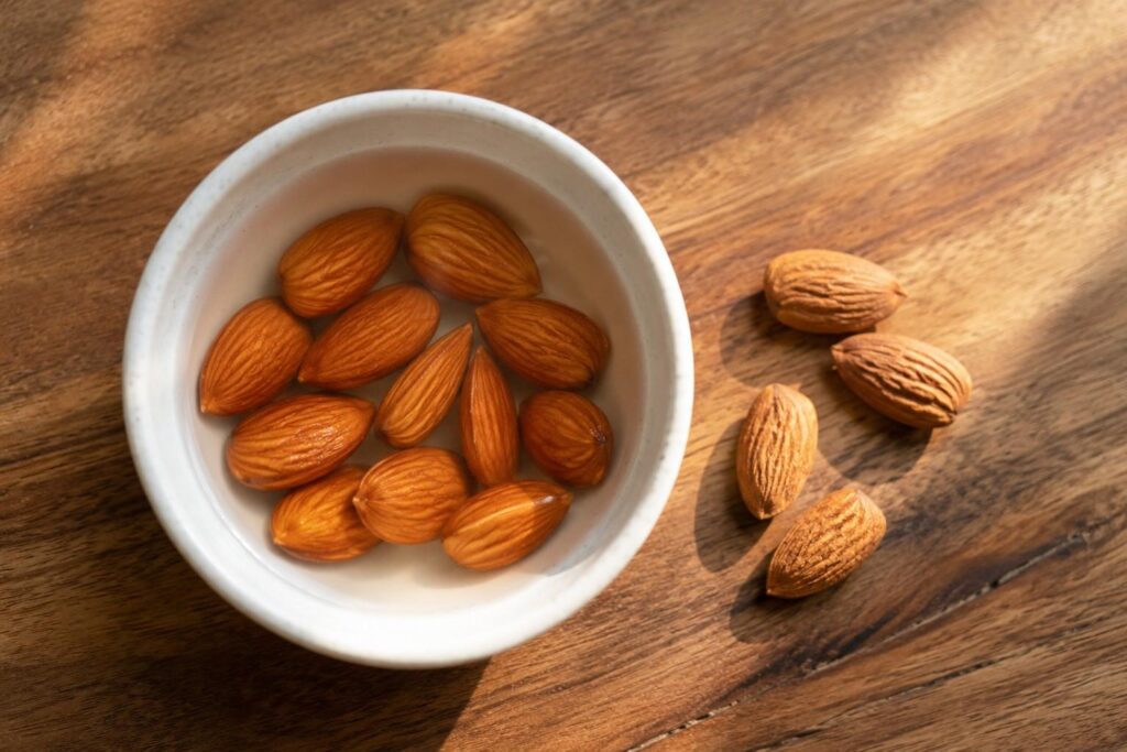  soaked almonds for hair growth in a white bowl